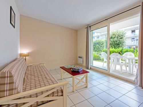 a living room with a couch and a table at Vacancéole - Le Domaine de Bertheaume in Plougonvelin
