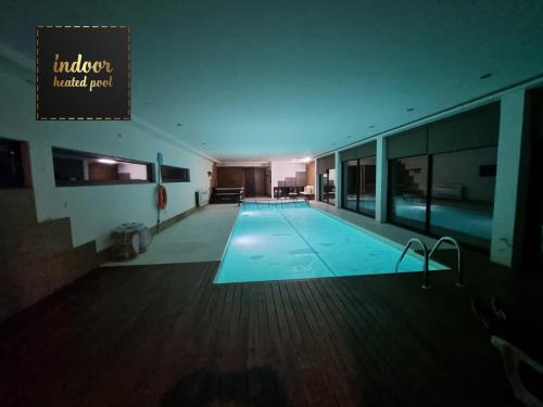 a large swimming pool in a large building at Villa Amor in Touguinho