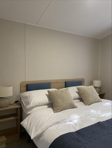 a bedroom with a white bed with two pillows at KellysHolidayHomes 26 Willerby 2 bedrooms caravan in Weeley