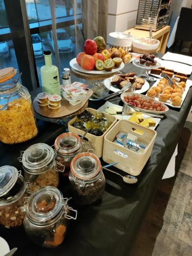 a table with many different types of food on it at Hotel Bienestar Moaña in Moaña