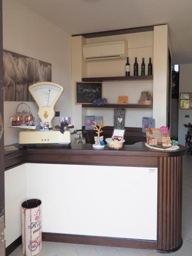 a counter in a store with bottles of wine at Mini-Appartamenti, Camere Lanterna Blu in Mombello Monferrato