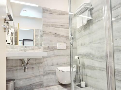 a bathroom with a toilet and a sink at Hotel Garden Court in Prague