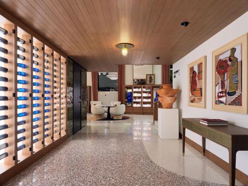 a living room with a wine cellar with wine bottles at H10 Croma Málaga in Málaga