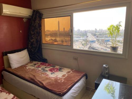 a small bedroom with a bed and a window at Isis Hostel 2 in Cairo