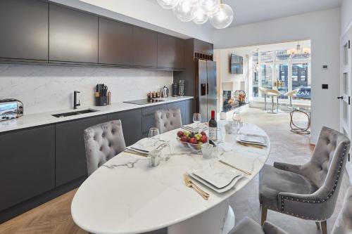 a kitchen and dining room with a white table and chairs at Host & Stay - Oxford House in Harrogate