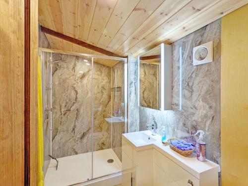 a bathroom with a shower and a sink at The Quail Cabin in Kirdford