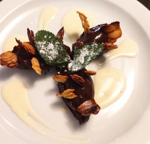a plate of food with chocolate and nuts on it at Hôtel Inn Design Resto Novo Langres in Langres