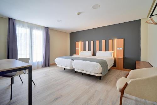 Postel nebo postele na pokoji v ubytování Smart Hotel La Sagra