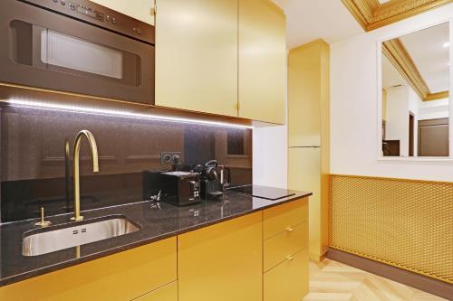 a kitchen with a sink and a microwave at Pick A Flat's Apartments in Champs Elysées - Rue du Colisée in Paris