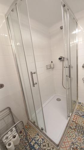a shower with a glass door in a bathroom at Casa em Alfama in Lisbon