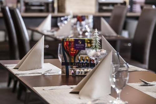 a table with wine glasses and napkins on it at Session Hotel Ráckeve in Ráckeve