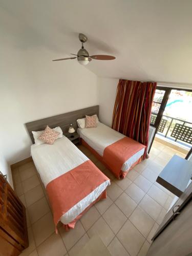 a bedroom with two beds and a window at Parquemar in Playa del Ingles