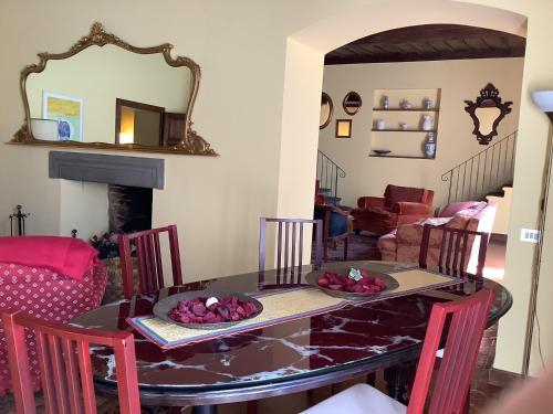a dining room with a table and chairs and a fireplace at Villa Rita in Vicopisano
