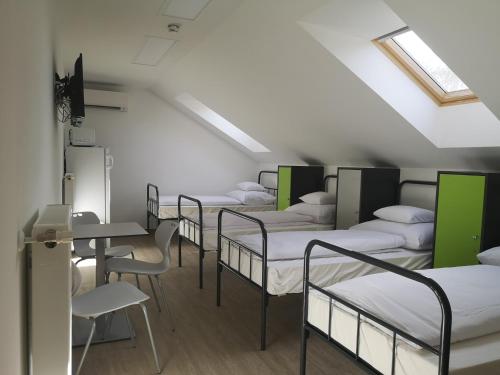 a row of bunk beds in a room at Ecostel Budaörs in Budaörs