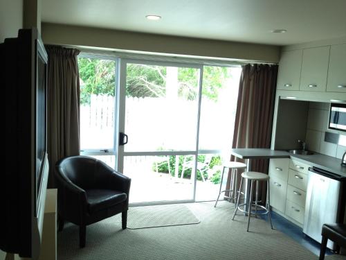 a kitchen with a table and chairs and a large window at Heriot Lane City Apartments in Dunedin