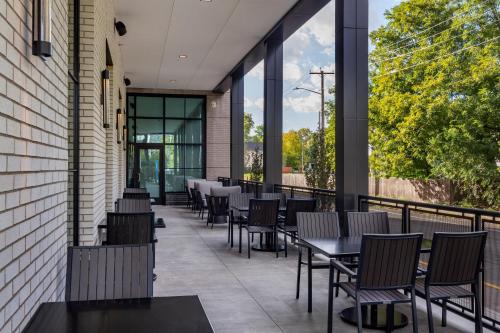 a row of tables and chairs on a patio at Cambria Hotel New Haven University Area in New Haven