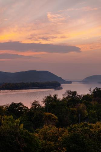 a view of a body of water at sunset at Akvarell Apartmanház in Zebegény