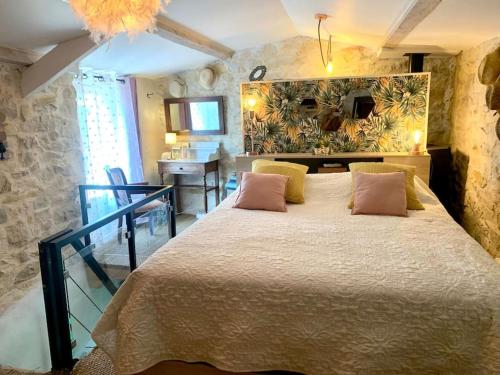 a bedroom with a large bed in a room at Maisonnette atypique cadarache-iter in Saint-Paul-lez-Durance