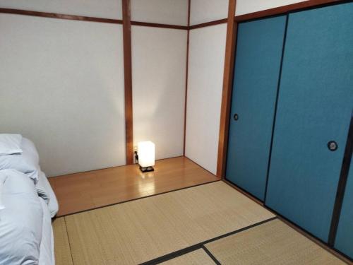 a room with a bed and a light in it at Ibaragi House in Kanazawa in Kanazawa