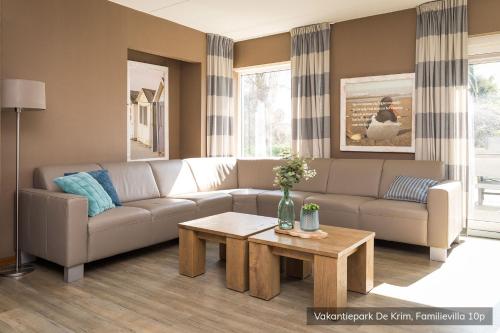 a living room with a couch and a coffee table at Vakantiepark De Krim Texel in De Cocksdorp