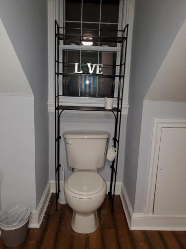 a bathroom with a white toilet in a room at Magnolias in Richmond