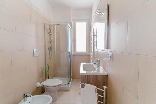 a bathroom with a toilet and a sink and a shower at GuestHost - Scaringi Palace B in Trani