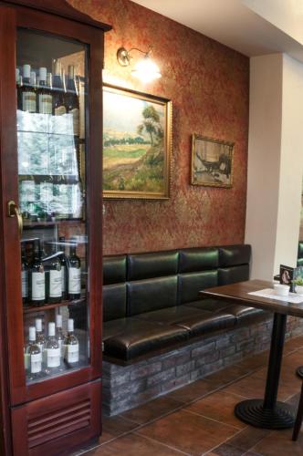 a bar with a leather bench in a room at Hotel Na Skalkách in Nový Jičín