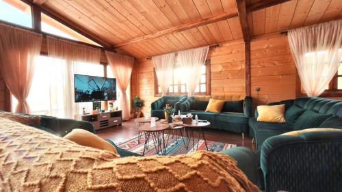 a living room with blue couches and a tv at شاليه الخفجي in Al Khafji