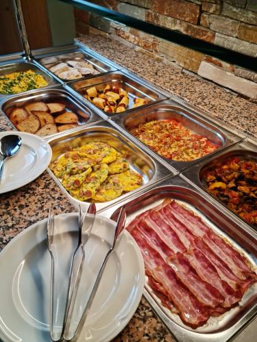 a buffet of different types of food on a counter at Restaurace a penzion Pod Lipami Metylovice in Metylovice