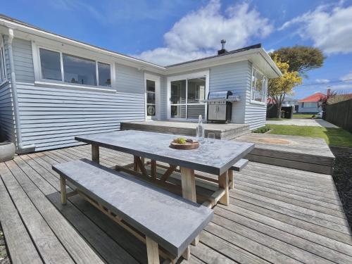 a picnic table on a deck in front of a house at - Welcome Home - 3brm Character, Close to Everything in Hamilton