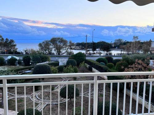 a view of a garden from a balcony at Lagonisi Luxury Apartment by the sea in Lagonissi