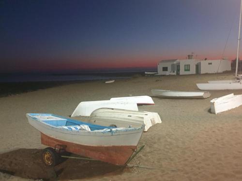 a boat sitting on the sand on a beach at Apartamento La Gaviota in Playa Honda