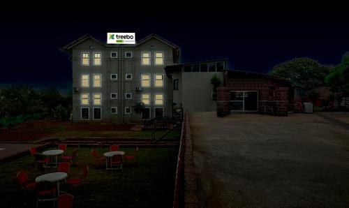 a building with a sign on top of it at night at Treebo Vhyomaan Resort in Mahabaleshwar