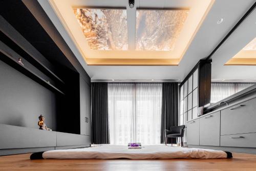 a bedroom with a large bed in front of a window at Avita Resort Bad Tatzmannsdorf in Bad Tatzmannsdorf