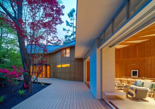 an external view of a house with a patio at SHISHI-IWA HOUSE Karuizawa in Karuizawa