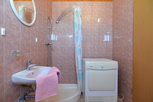 a bathroom with a sink and a shower at Apartments Tanja 349 in Peroj