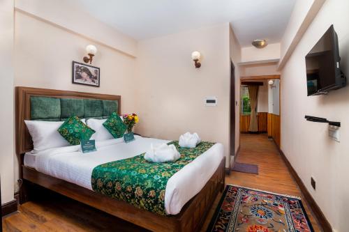 a bedroom with a large bed in a room at Muscatel Roma - 400 Mts from Mall Road in Darjeeling