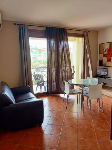 a living room with a couch and a table and chairs at Sal&Love apt in Porto Antigo in Santa Maria