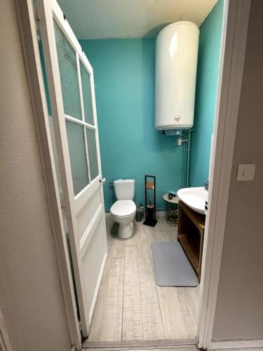 une salle de bain bleue avec des toilettes et un lavabo dans l'établissement Appartement au coeur de Dinard - T2, à Dinard