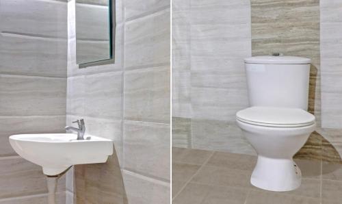 a bathroom with a toilet and a sink at Itsy Hotels Infinity, Hitech City in Hyderabad