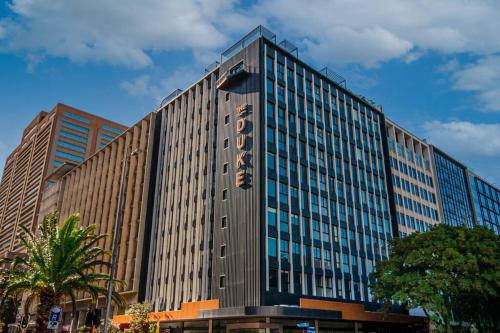 a large building with a sign on the side of it at Brand new, luxury, wifi, pool with 24hr security in Cape Town