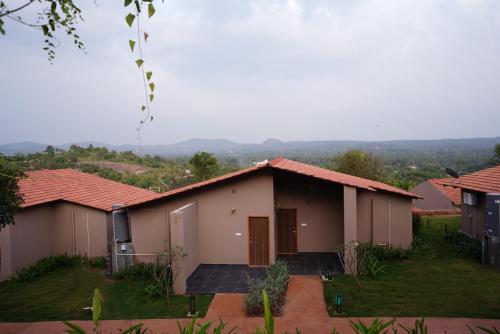a house with a view of a mountain at Ravishing Retreat Resort in Rāmanagaram