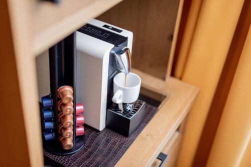 a cup holder with a toothbrush and a mug in it at Avita Resort Bad Tatzmannsdorf in Bad Tatzmannsdorf