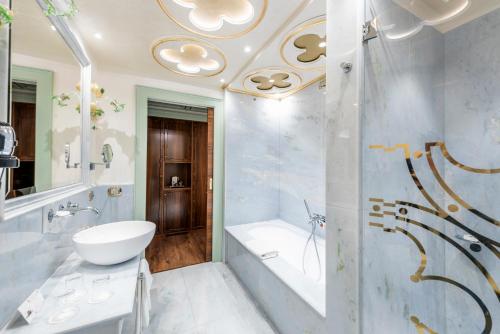 a bathroom with a tub and a sink and a toilet at Monaco & Grand Canal in Venice