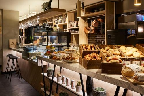 a bakery with many different types of bread and pastries at Hotel Indigo Antwerp City Centre by IHG in Antwerp