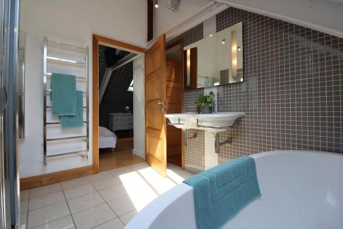 a bathroom with a sink and a mirror at The Old Methodist Chapel in Great Massingham