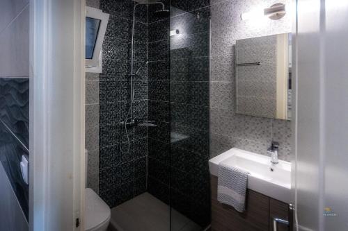 a bathroom with a shower and a sink and a toilet at Chandris Apartments in Kavos