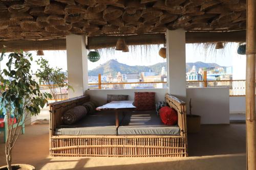 a couch sitting on a porch with a table at The Brahma Space in Pushkar