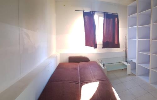 a room with a couch and a window and a table at Cozy Flat with Parking well-placed near TLV Airport in Lod