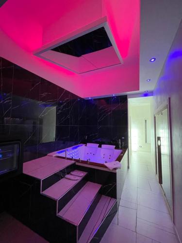 a bathroom with pink lights on the ceiling at Suite Élite in Catania